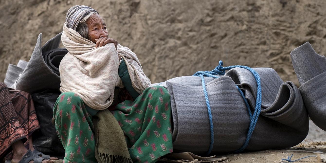 An elderly earthquake survivor waits for transport after receiving a Winterisation Kit - Credit: Kieran Doherty/Oxfam An elderly earthquake survivor waits for transport after receiving a Winterisation Kit - Credit: Kieran Doherty/Oxfam